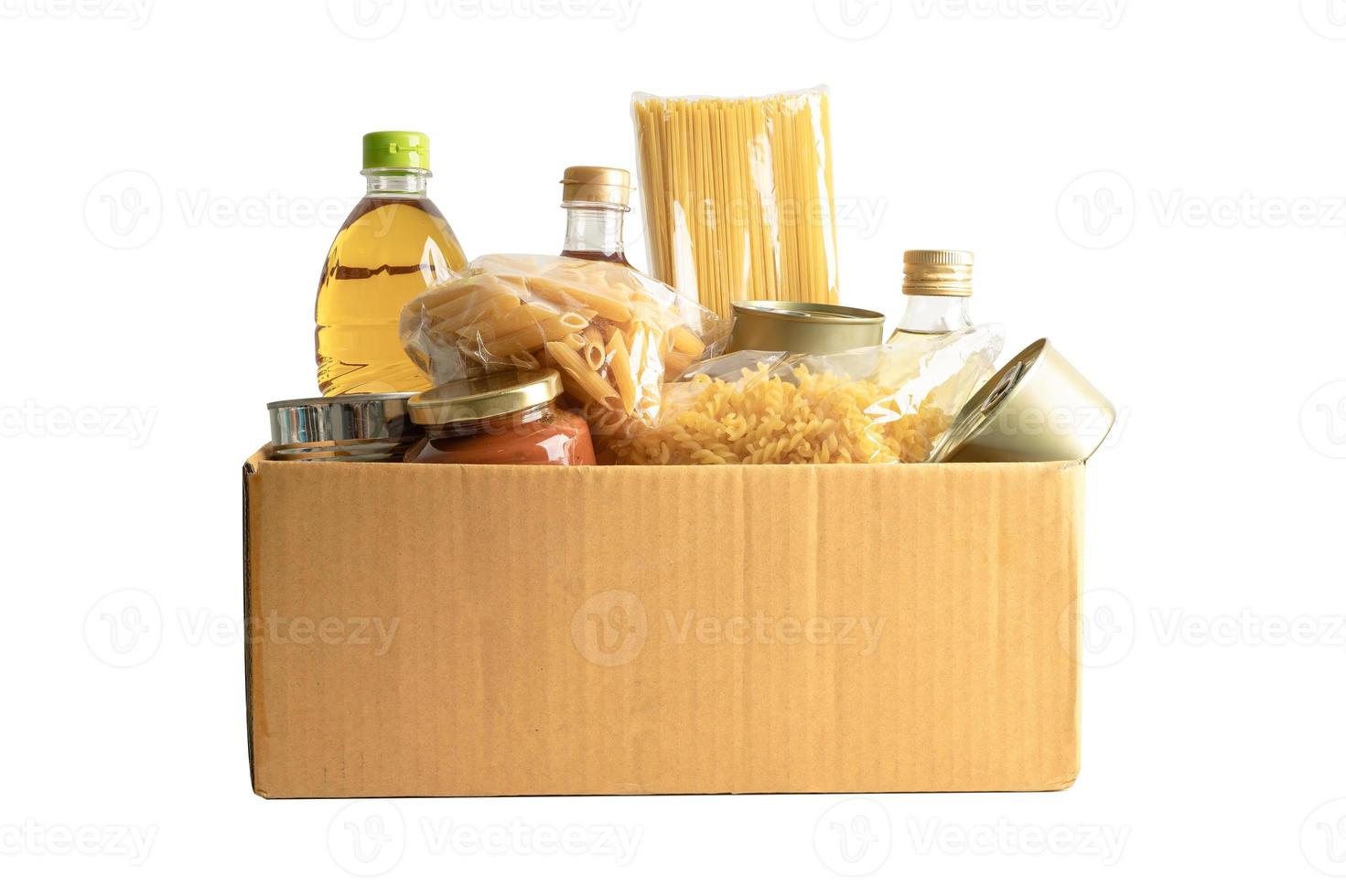 Foodstuff for donation, storage and delivery. Various food, pasta, cooking oil and canned food in cardboard box. photo