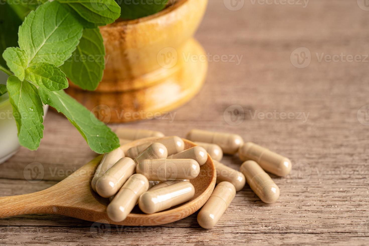 Alternative medicine herbal organic capsule drug with herbs leaf natural supplements for healthy good life. photo