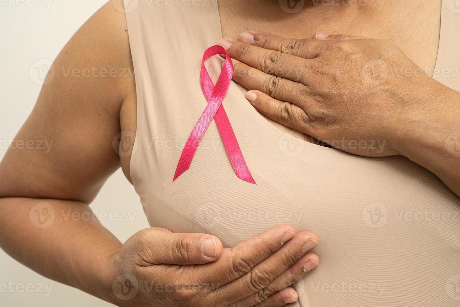 Breast cancer, pink ribbon at Asian senior lady for supporting awareness, symbol of World Breast Cancer Day. photo