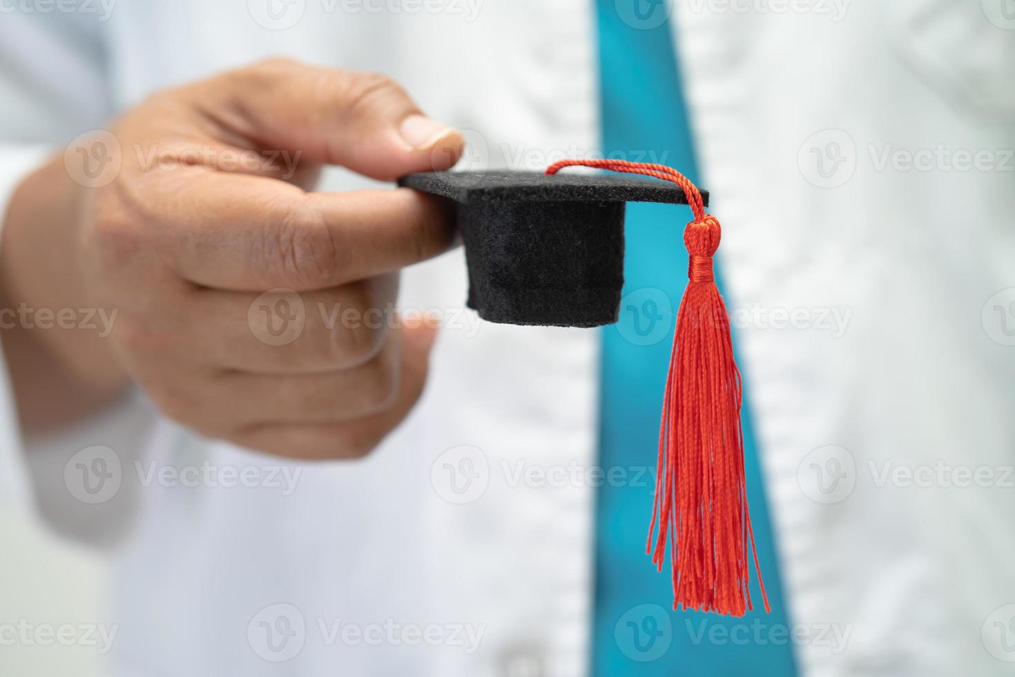 Asian doctor study learn with graduation gap hat in hospital ward, clever bright genius education medicine concept. photo