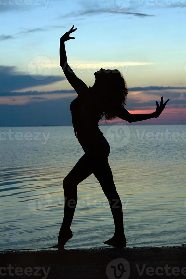 Silhouette of a young woman photo