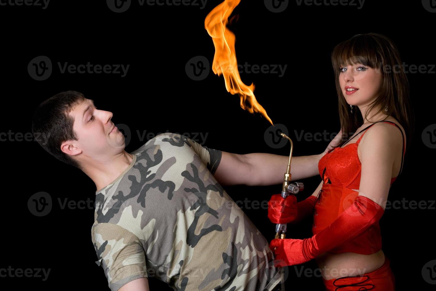 Young woman with a gas torch and scared man. Isolated photo