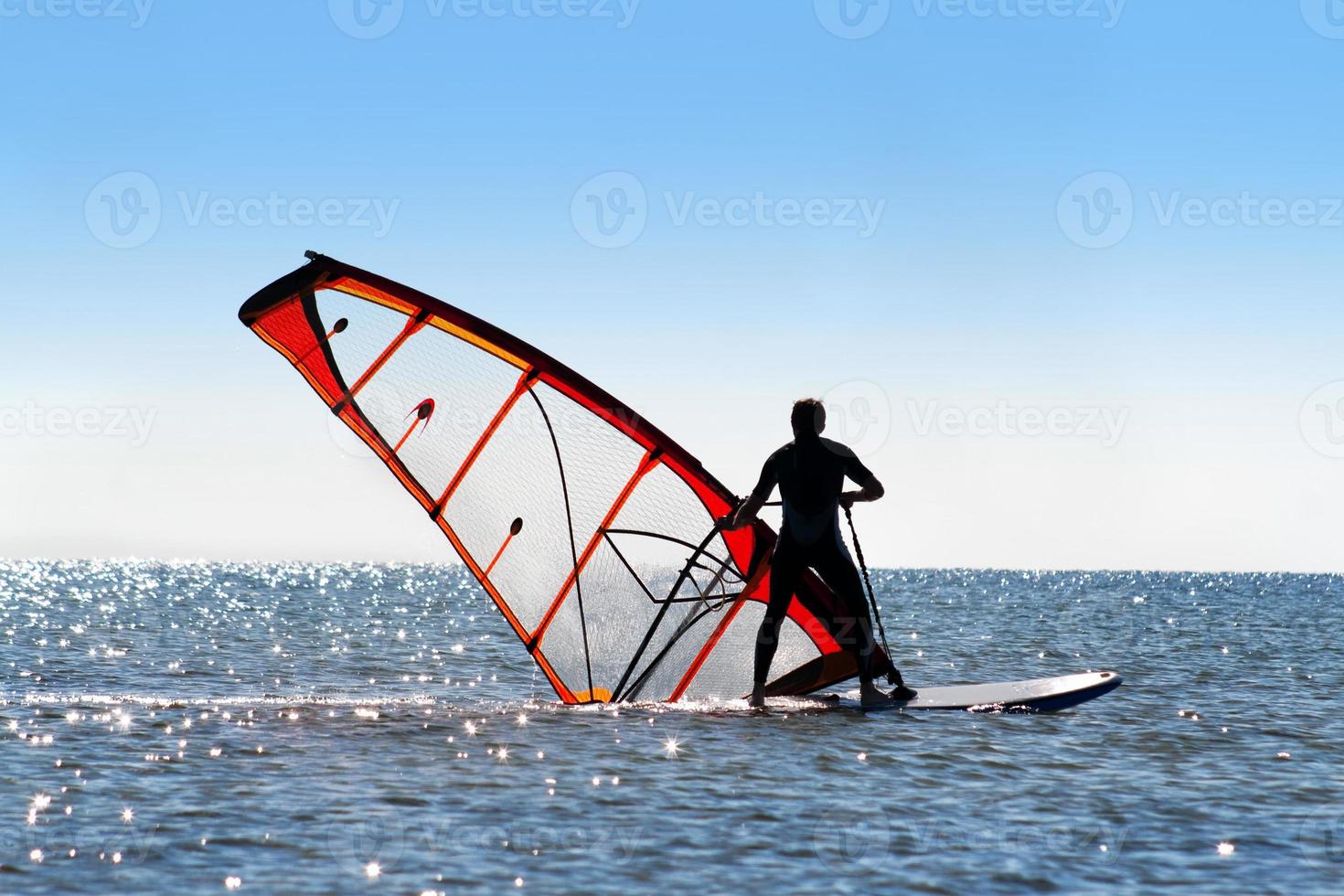 Windsurfer picks up the sail photo