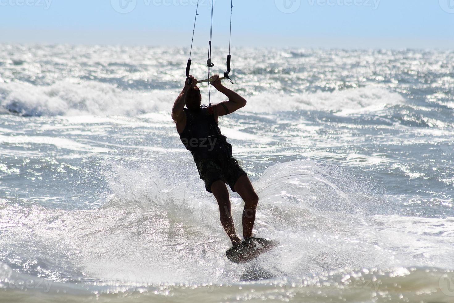 Silhouette of kite surfer photo