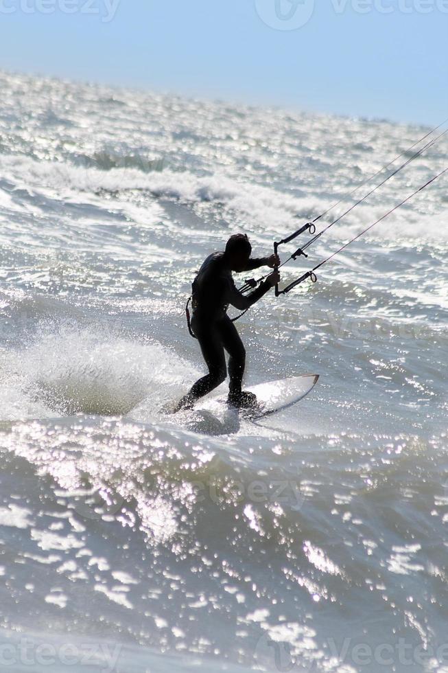 Silhouette of kite surfer photo