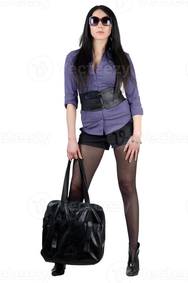 Beautiful young brunette with a black handbag photo