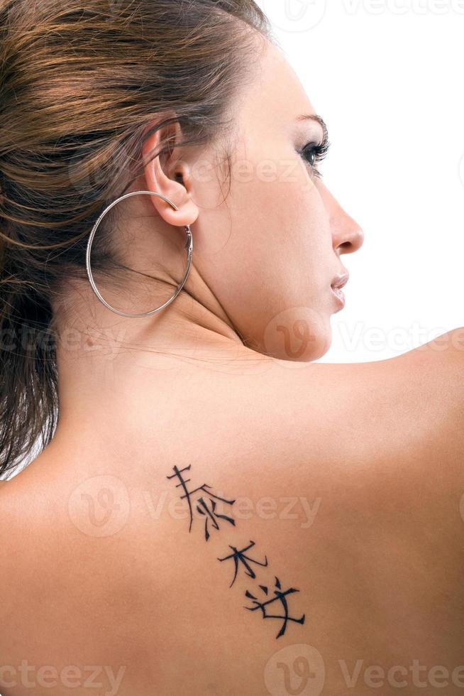 Tattoo on a back of the young woman. Isolated 3 photo