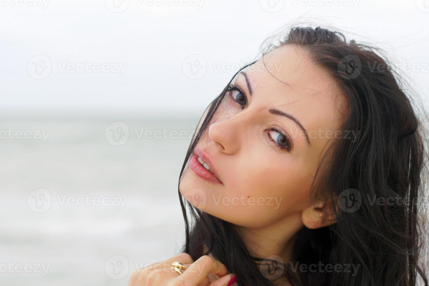 cute young woman on the beach photo
