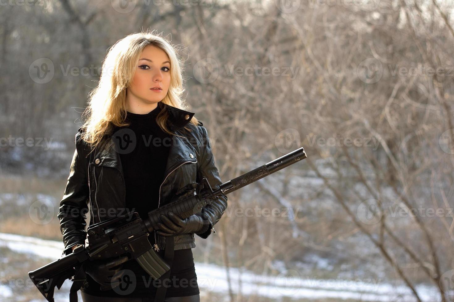 attractive young blonde with a gun photo