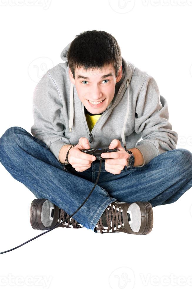 Young man with a joystick for game console photo