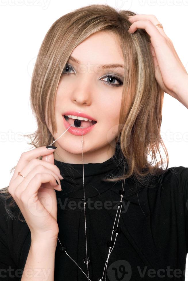 Portrait of beautiful girl with a bead in her mouth photo