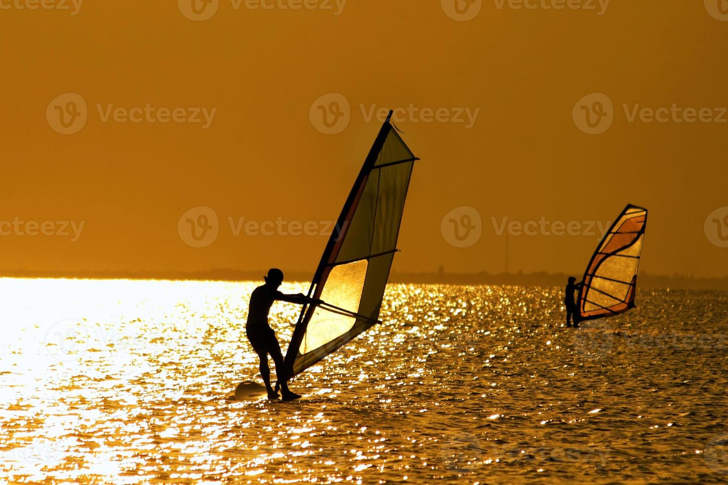 Two windsurfers over the sunset photo