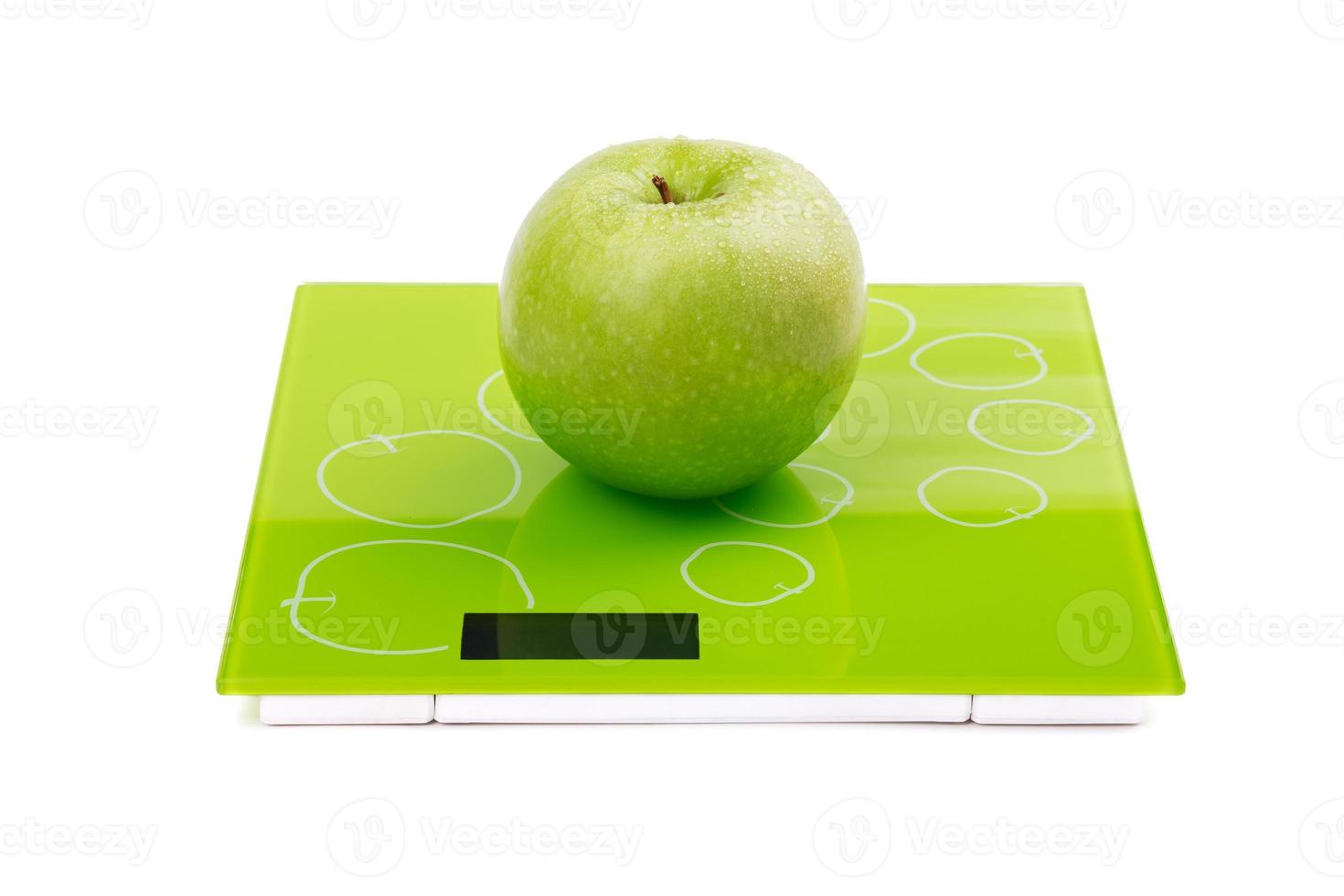 Green apple on scales 18941383 Stock Photo at Vecteezy