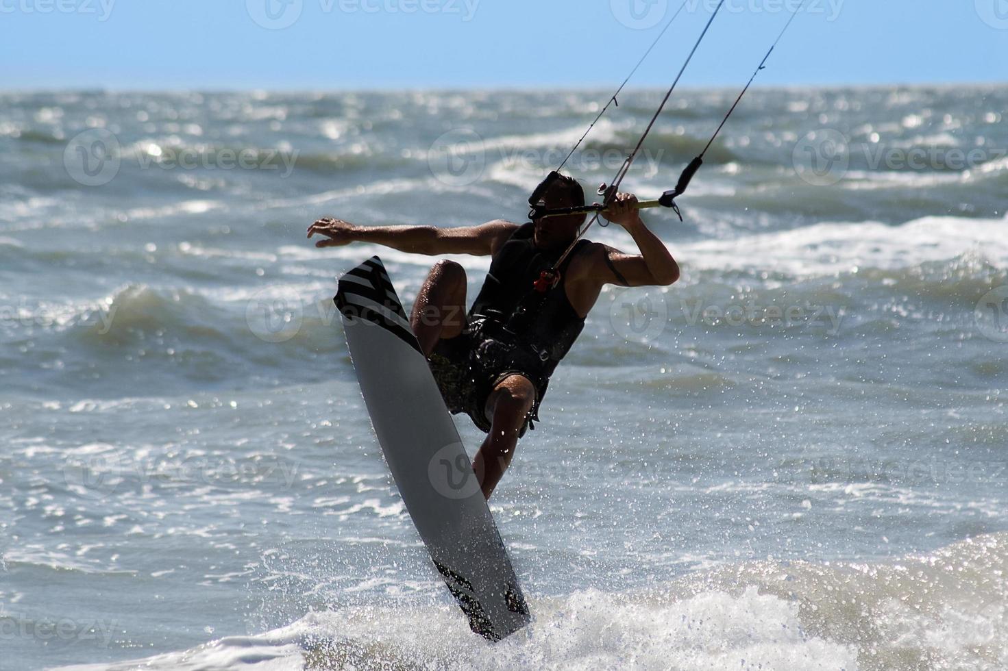 Kite surfer jumping and flying high photo