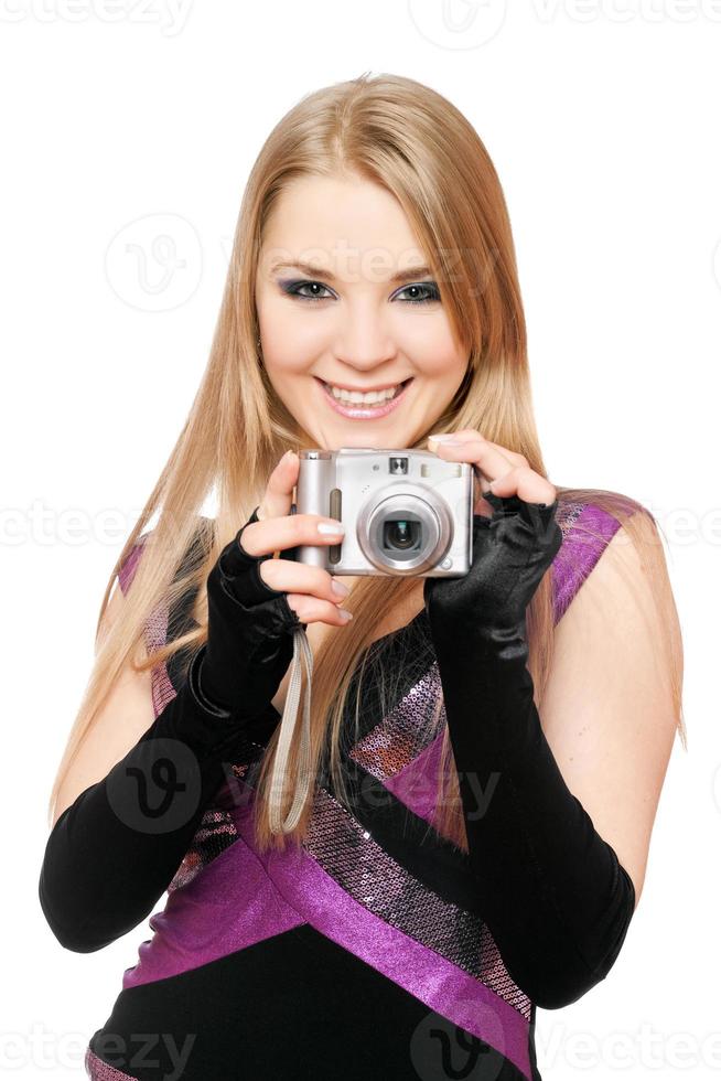 Smiling blonde holding a photo camera. Isolated