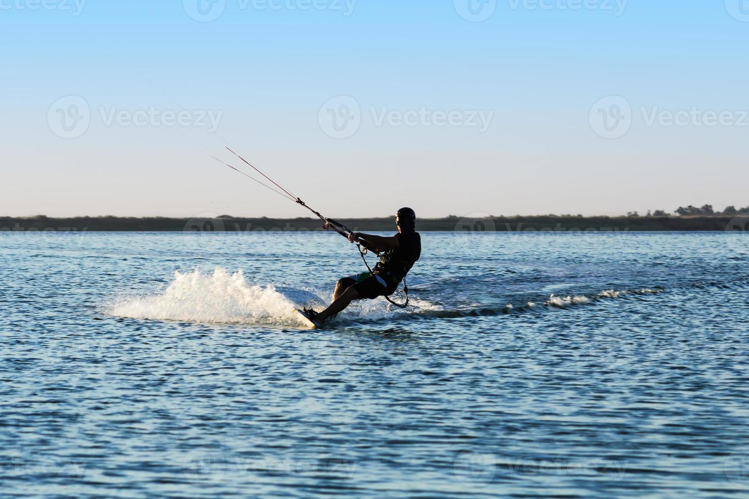 Silhouette of a kitesurfer photo