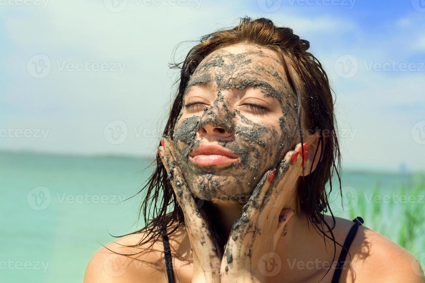 Woman with clay facial mask photo