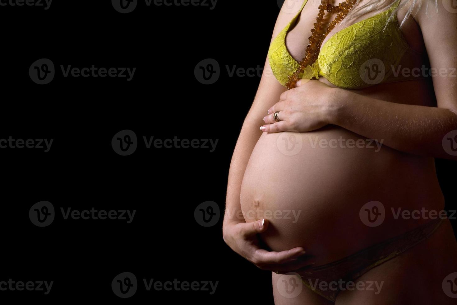 Belly of a pregnant girl. Isolated photo