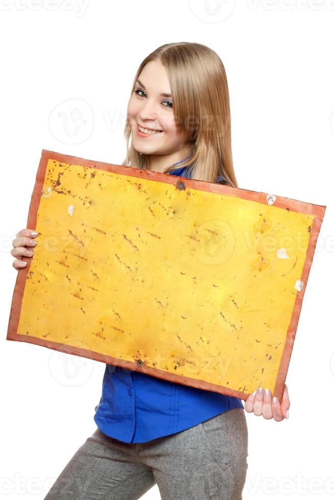 Cheerful young woman posing with yellow vintage board photo