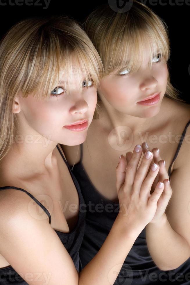 Young beautiful blonde and her reflection in a mirror photo