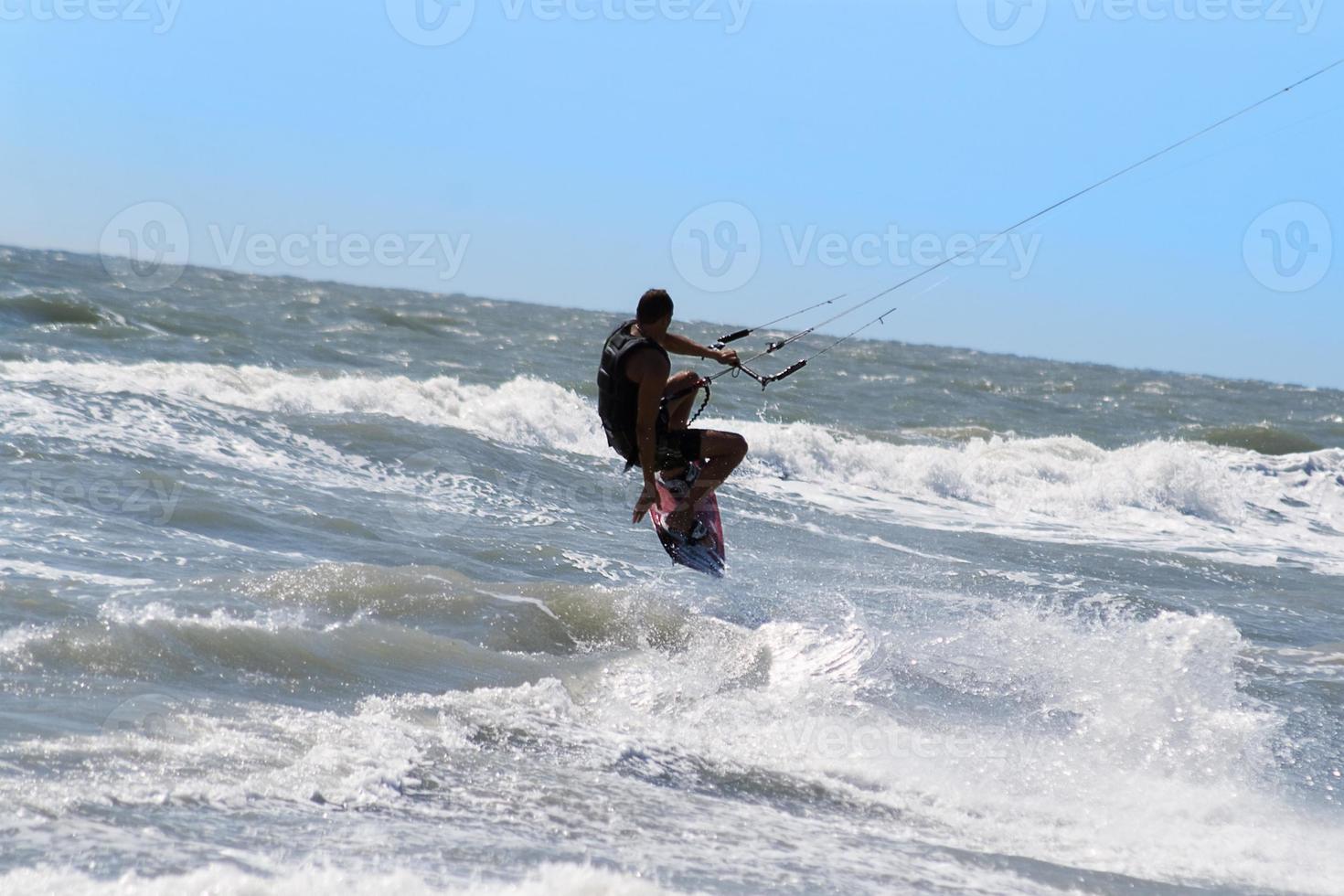 Silhouette of kite surfer photo