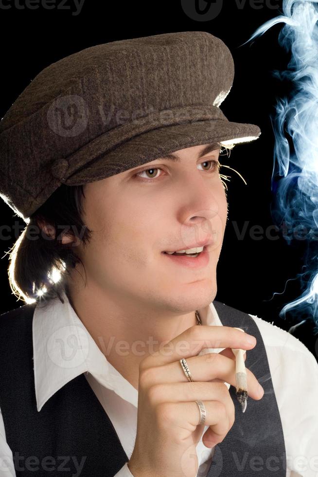 Young man smoking a cigarette in vintage clothes photo