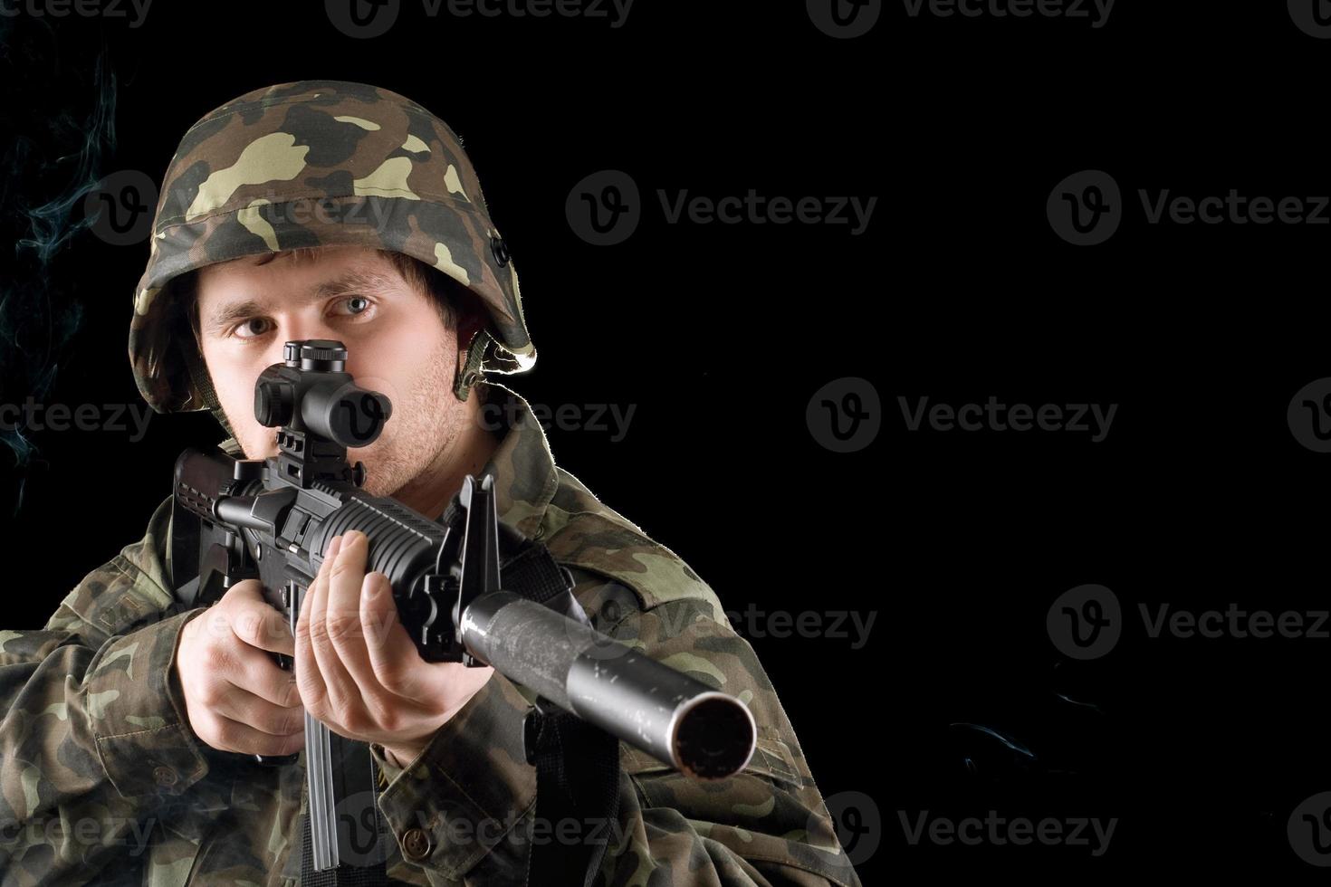 Man keeping a gun in studio photo