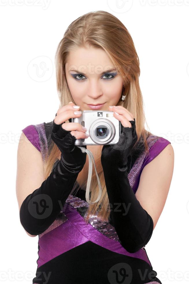 Young attractive blonde holding a photo camera. Isolated