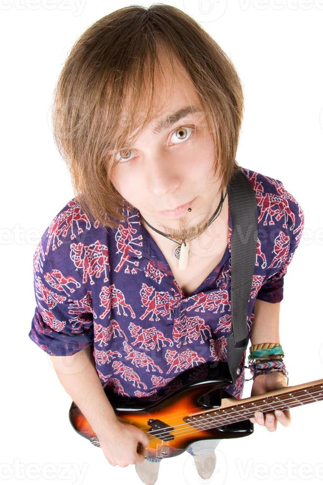 The young man with a guitar over white photo