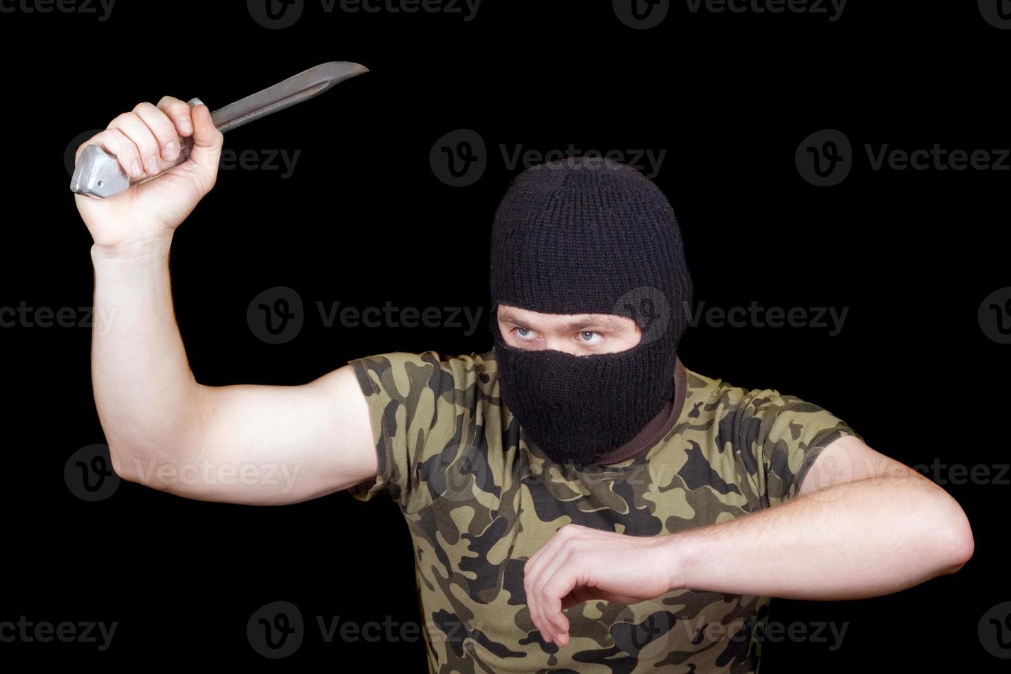 The murderer with a knife in a black mask photo