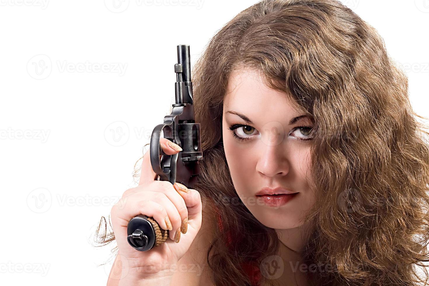 Young woman with a pistol. Isolated on white photo