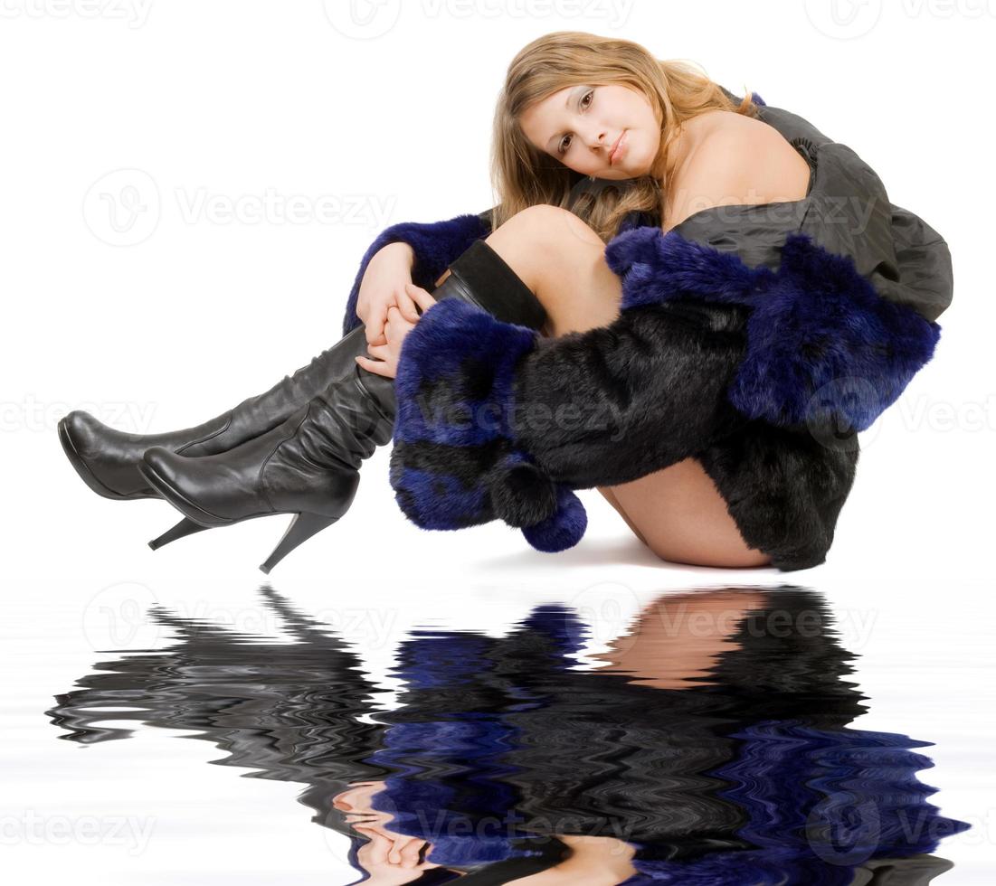 The young beautiful woman in a fur coat and boots photo