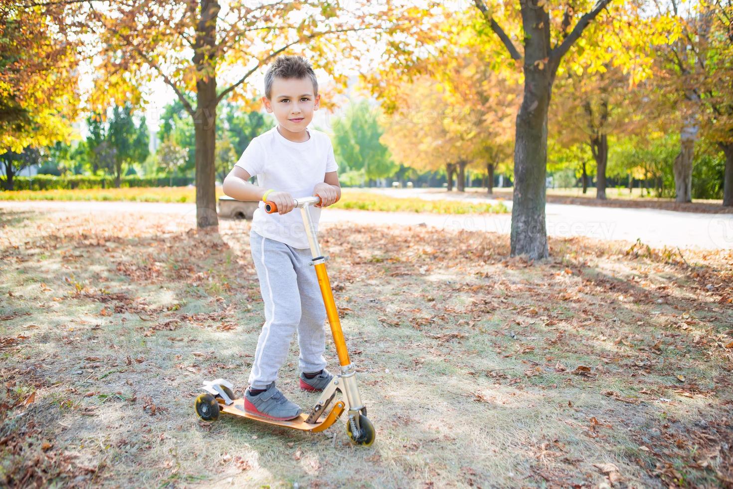 Playful boy on a scooter photo