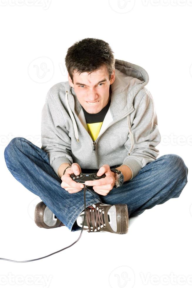 Furious young man with a joystick for game console photo