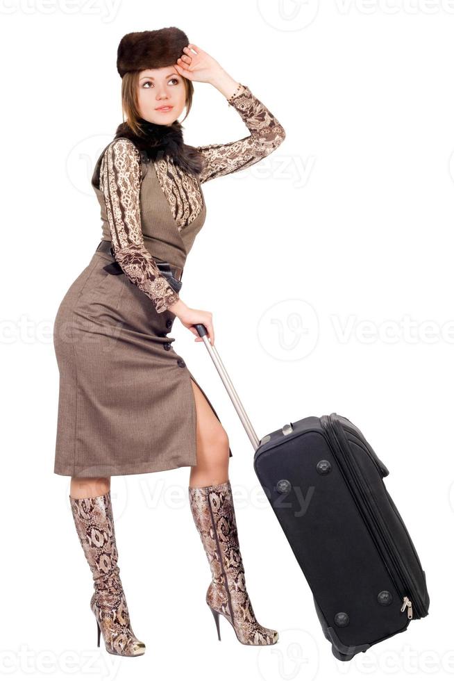 Young lady with a suitcase. Isolated on white photo