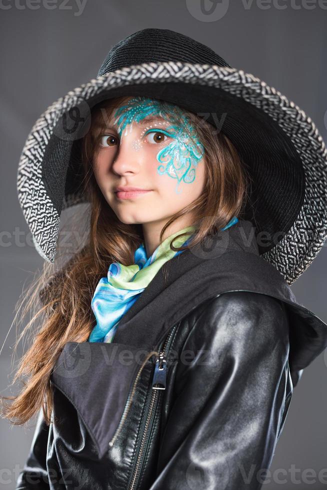 Young girl in black hat and jacket photo