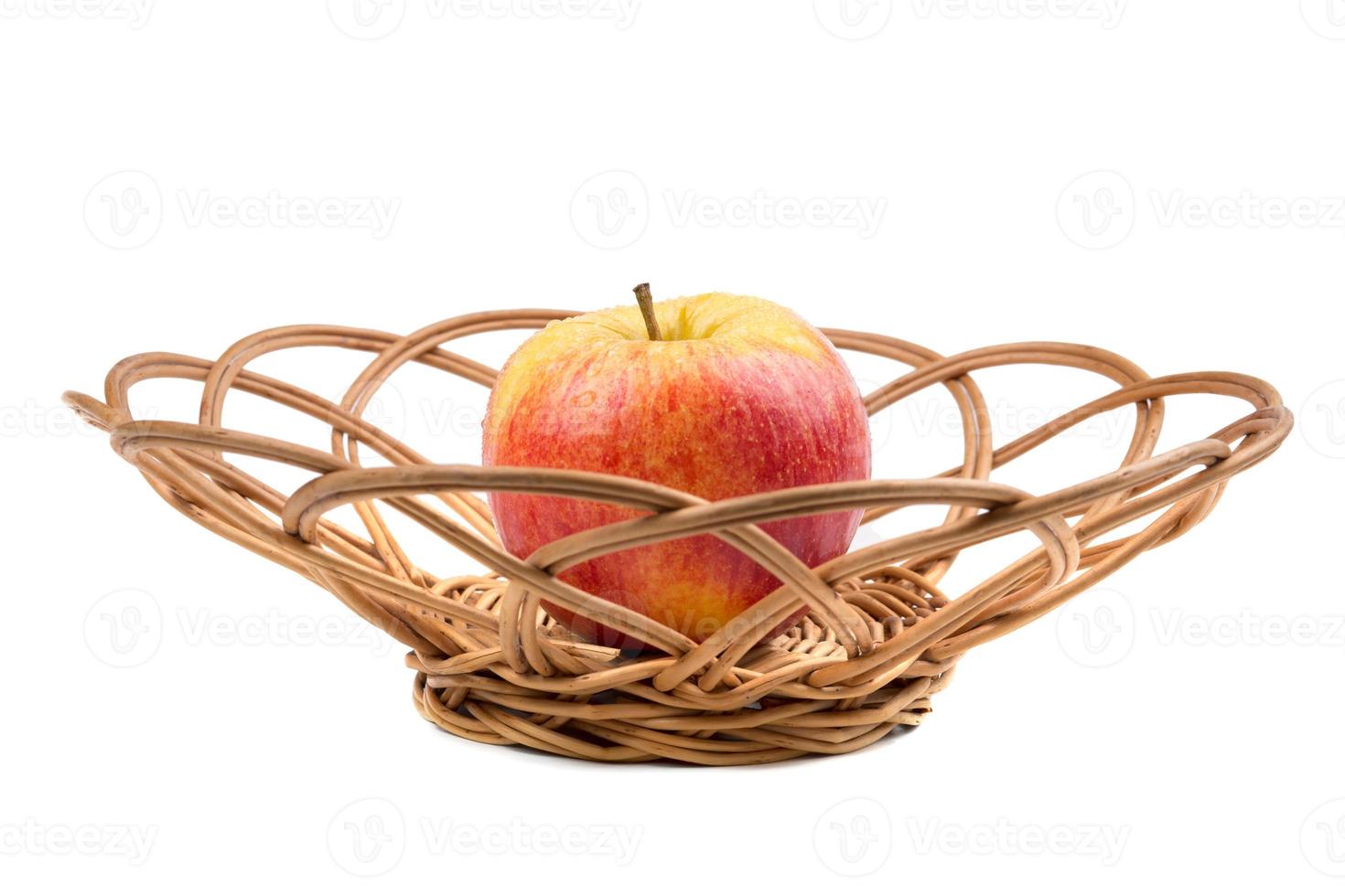 Sweet red apple in wicker photo