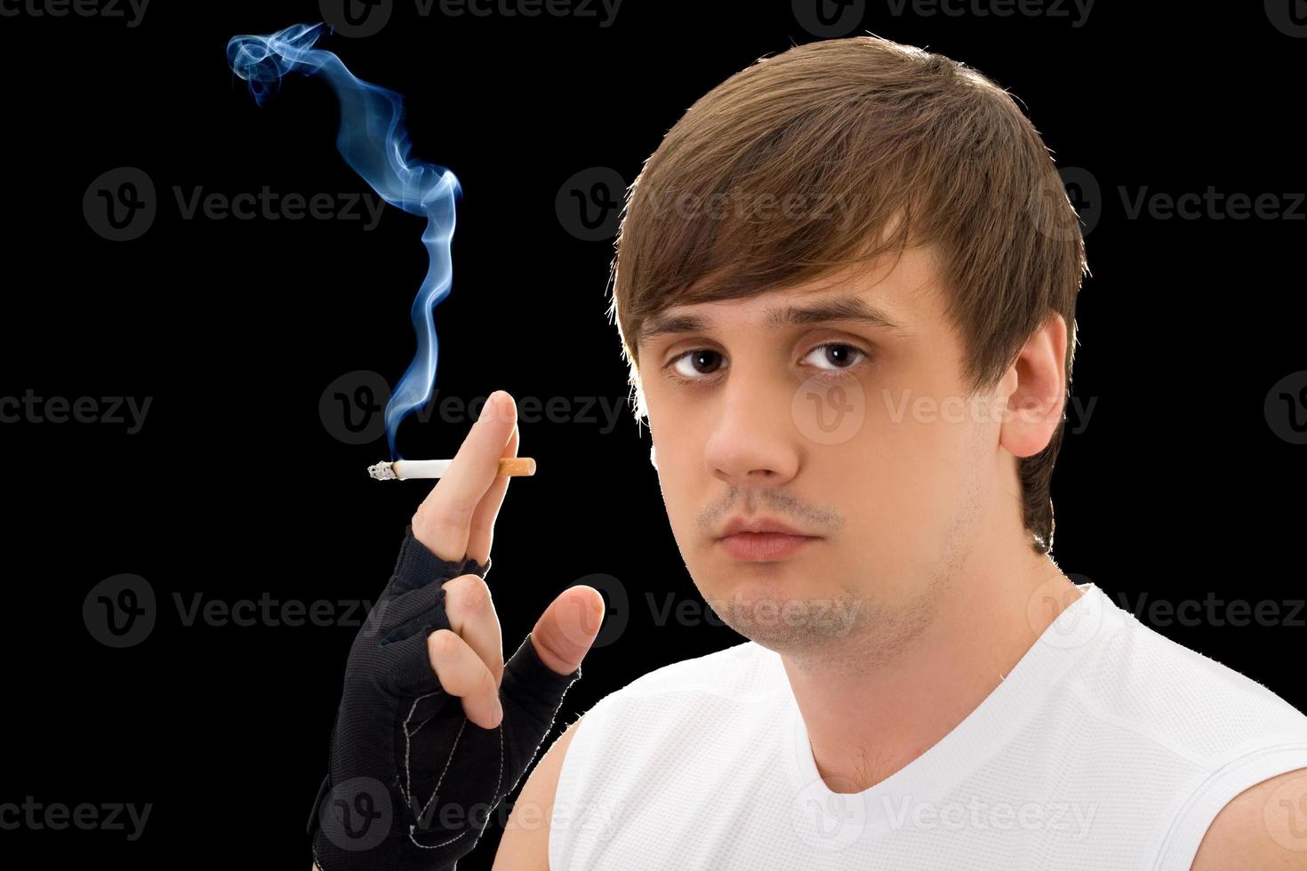 Portrait of the young man with a cigarette. Isolated photo