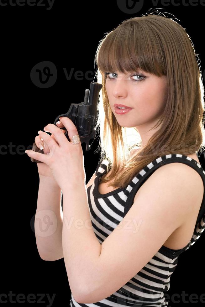 Attractive young woman with pistol. Isolated on black photo