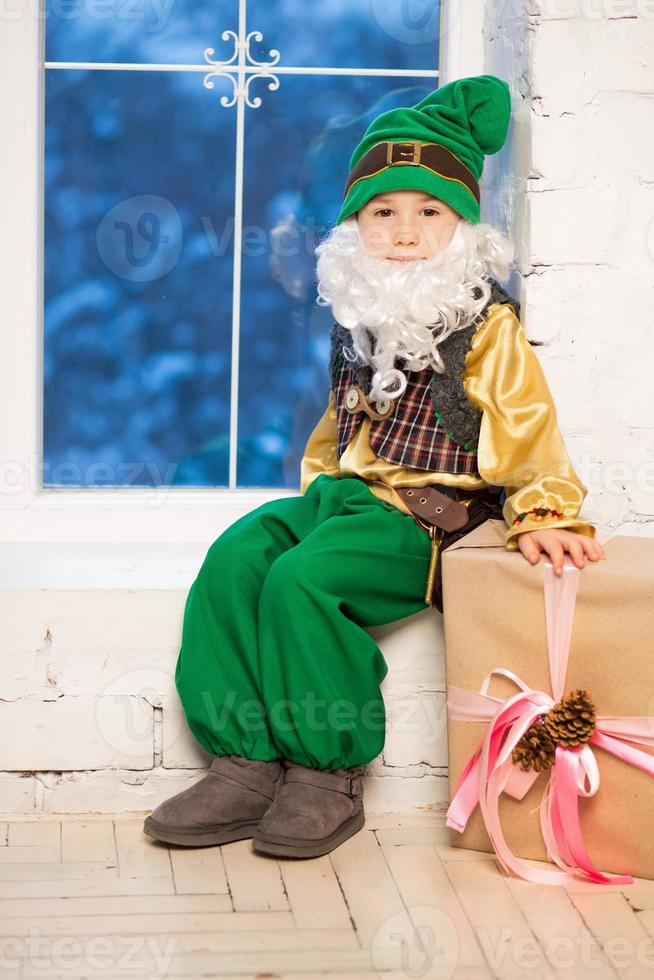 Funny boy posing in a gnome costume photo