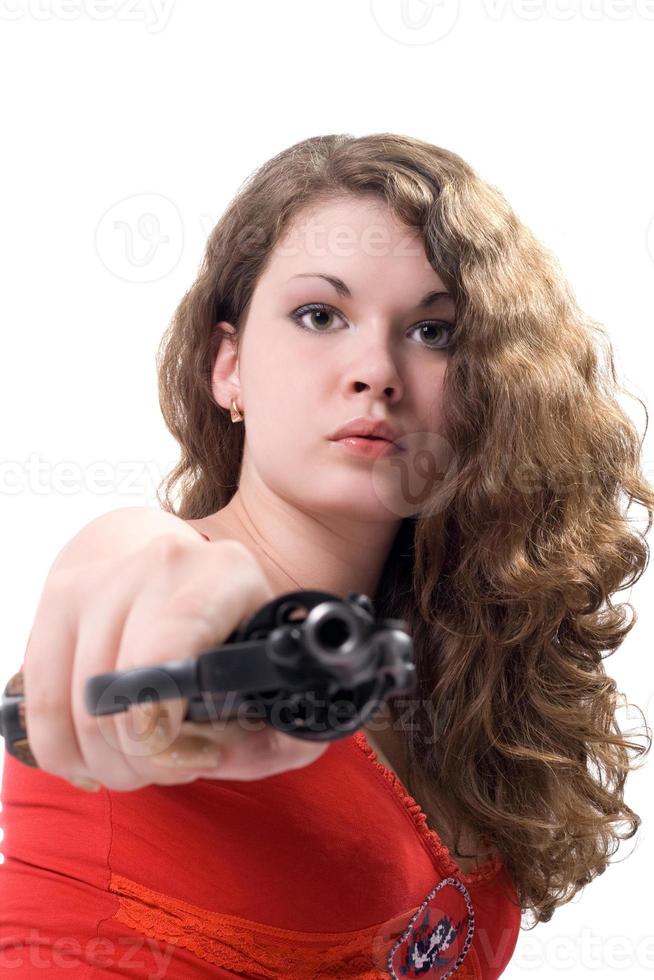 Young woman with a revolver. Isolated on white photo