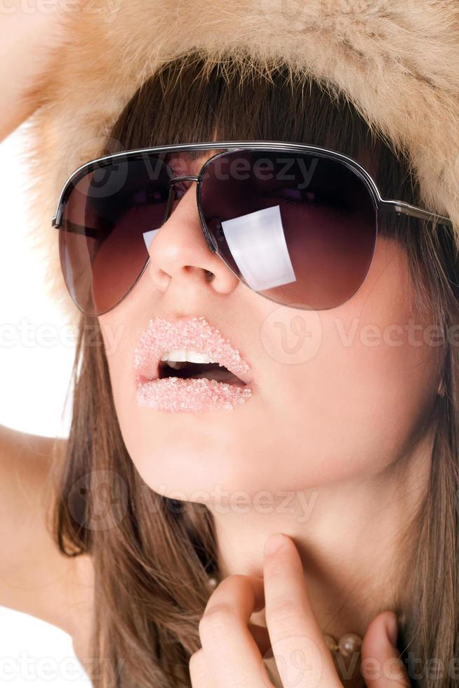 sexy woman wearing sunglasses with sugar lips photo