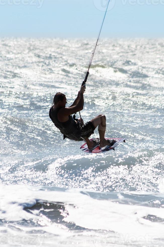 Silhouette of kite surfer photo