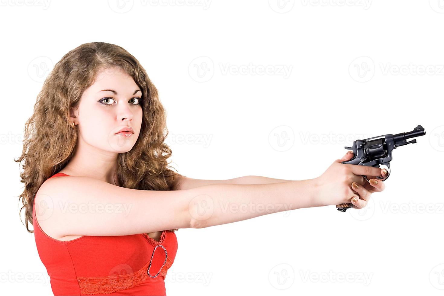 Young woman with a revolver. Isolated on white photo