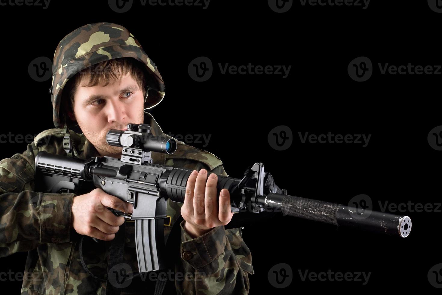 Aiming soldier with a rifle photo