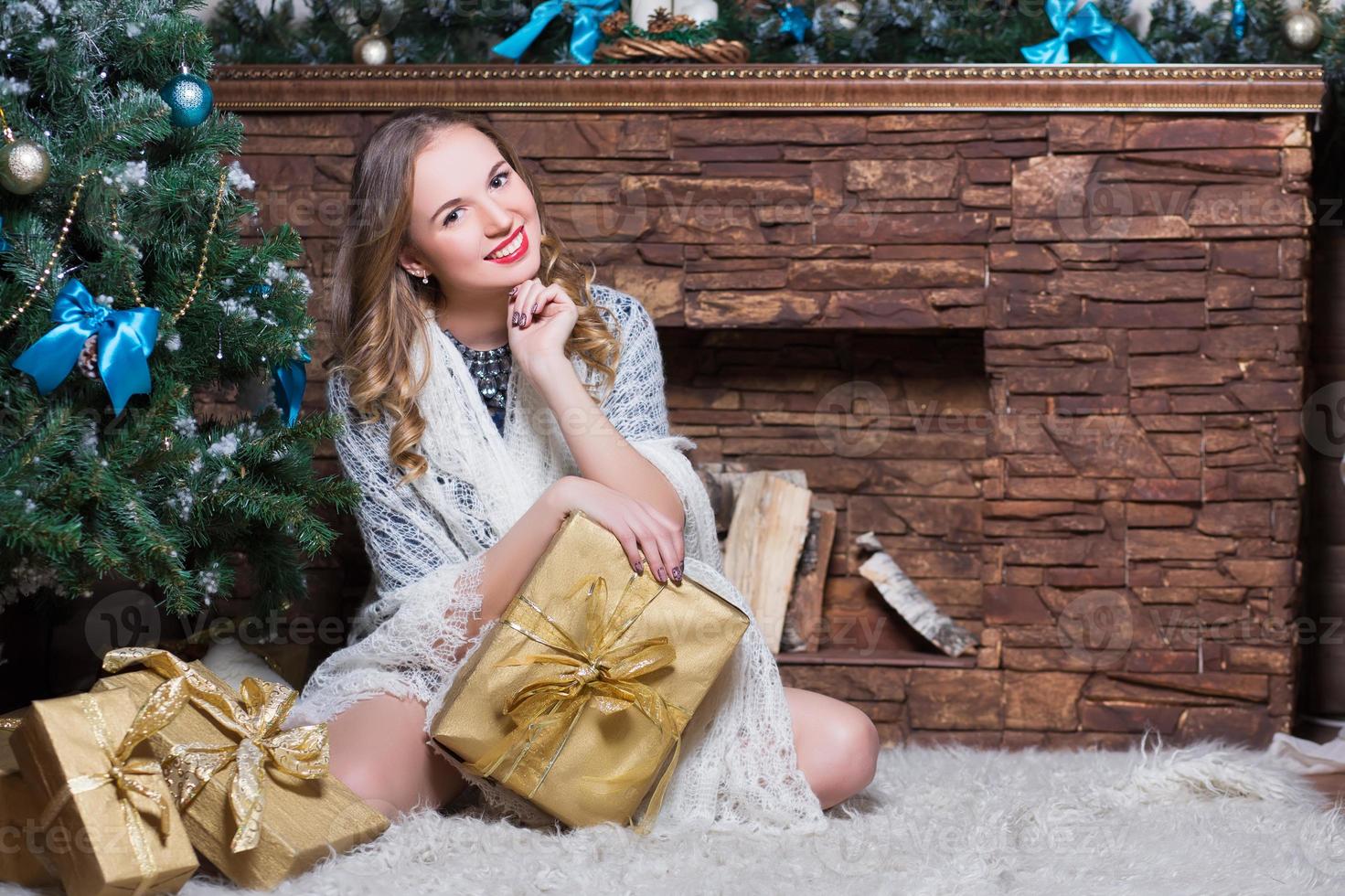 Attractive woman sitting on the carpet photo