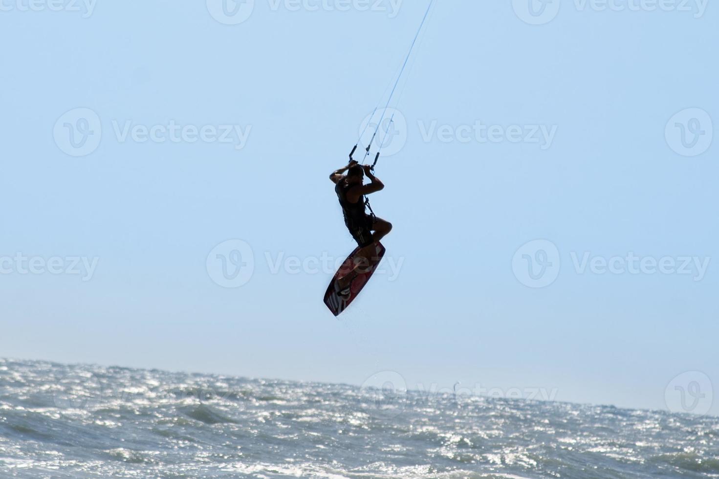 Silhouette of kite surfer photo