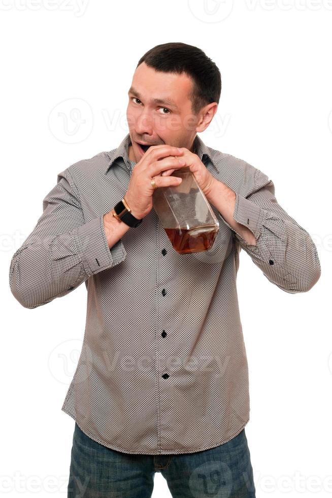 Man opens a bottle of whiskey photo