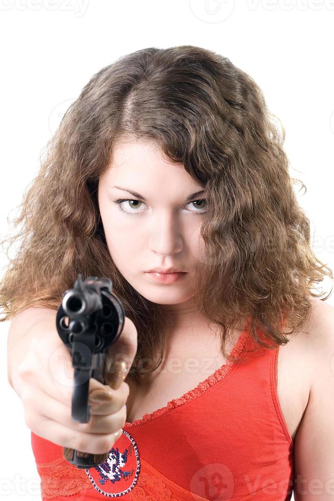 Young woman with a pistol. Isolated on white background photo