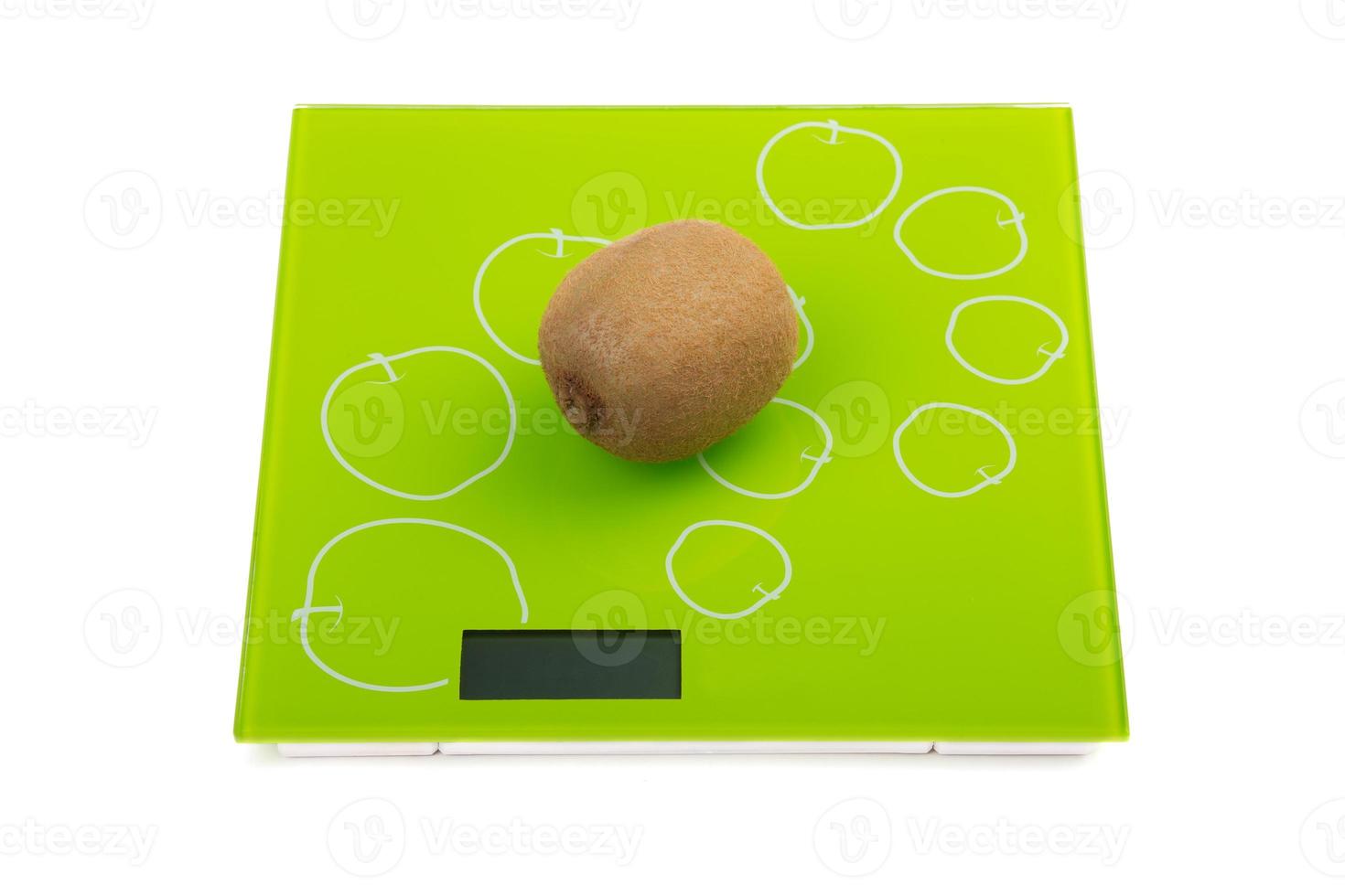 Kiwi fruit on kitchen scales photo